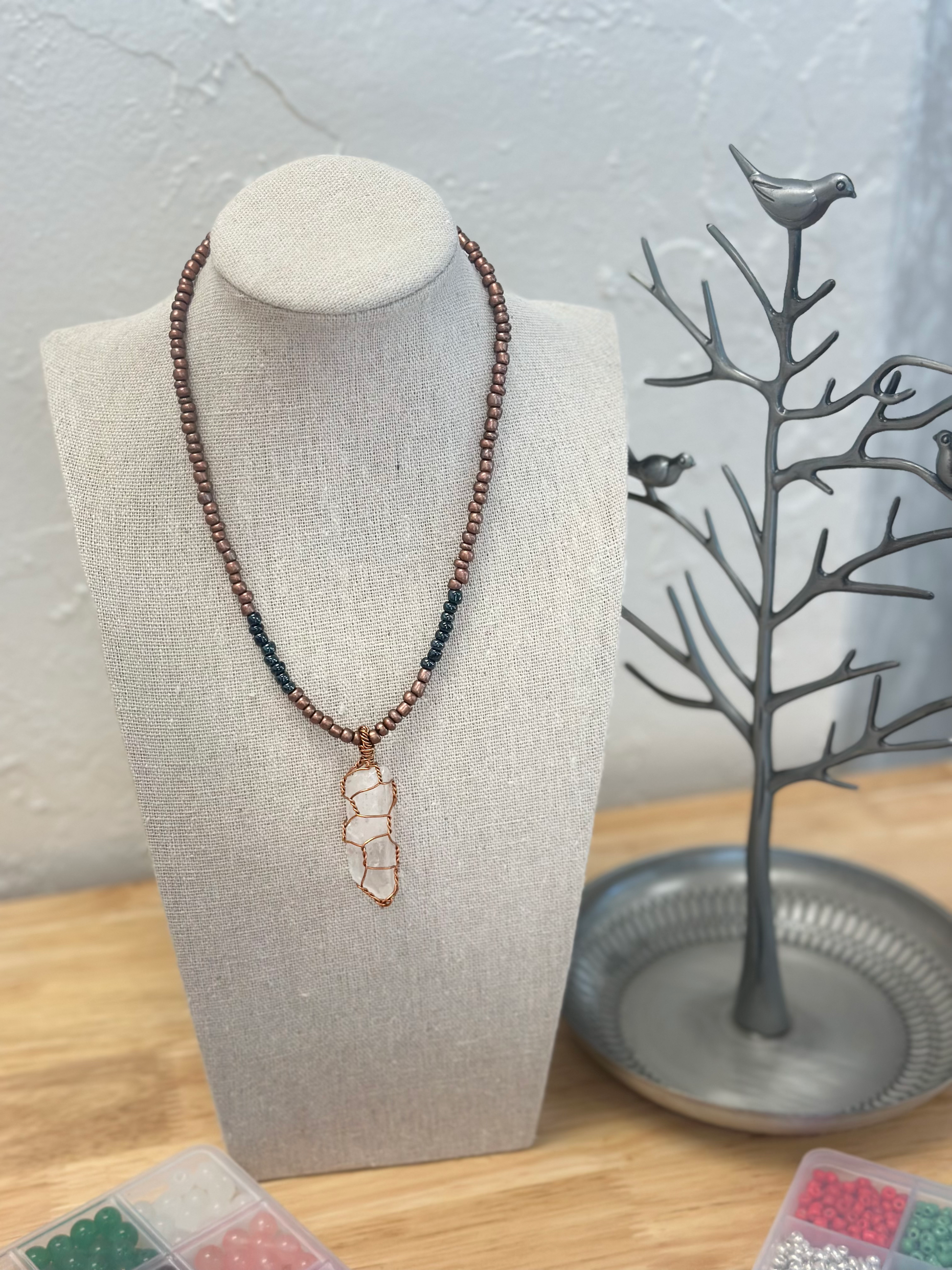 Beaded necklace with wire-wrapped crystal pendant